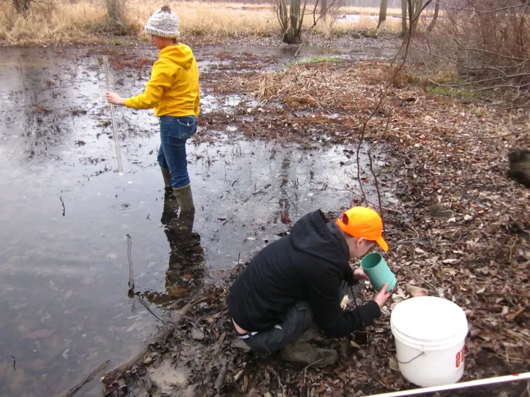 Students collecting water samples at Blackfork Wetlands